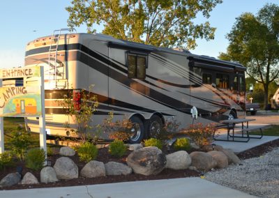 A large rv parked in front of some rocks.