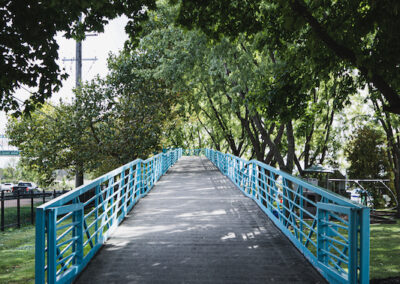 A blue bridge with trees in the background