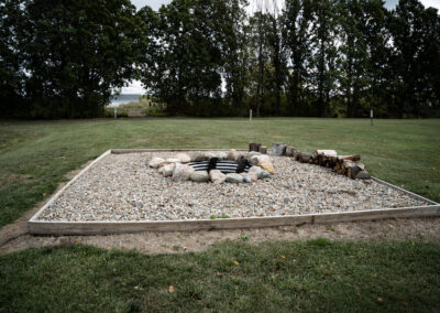 A fire pit in the middle of a field.