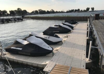 A row of jet skis parked on the dock.