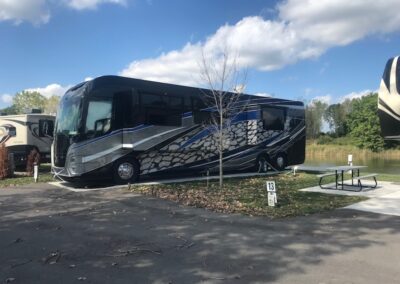 A black and silver bus parked in the parking lot.