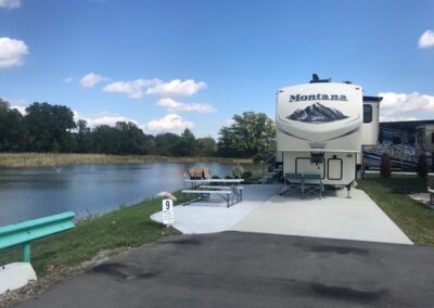 A large rv parked next to the water.