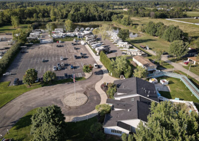 An aerial view of a parking lot with many cars parked in it.